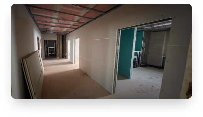 Flur im Ausbau mit beplankten Trockenbauwänden und Decke
